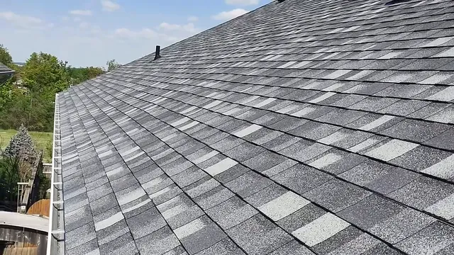 A long run of new grey shingles down to the eavestrough
