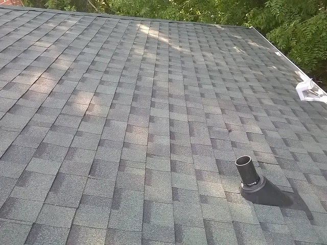 Grey shingles laid neatly around a plumbing vent